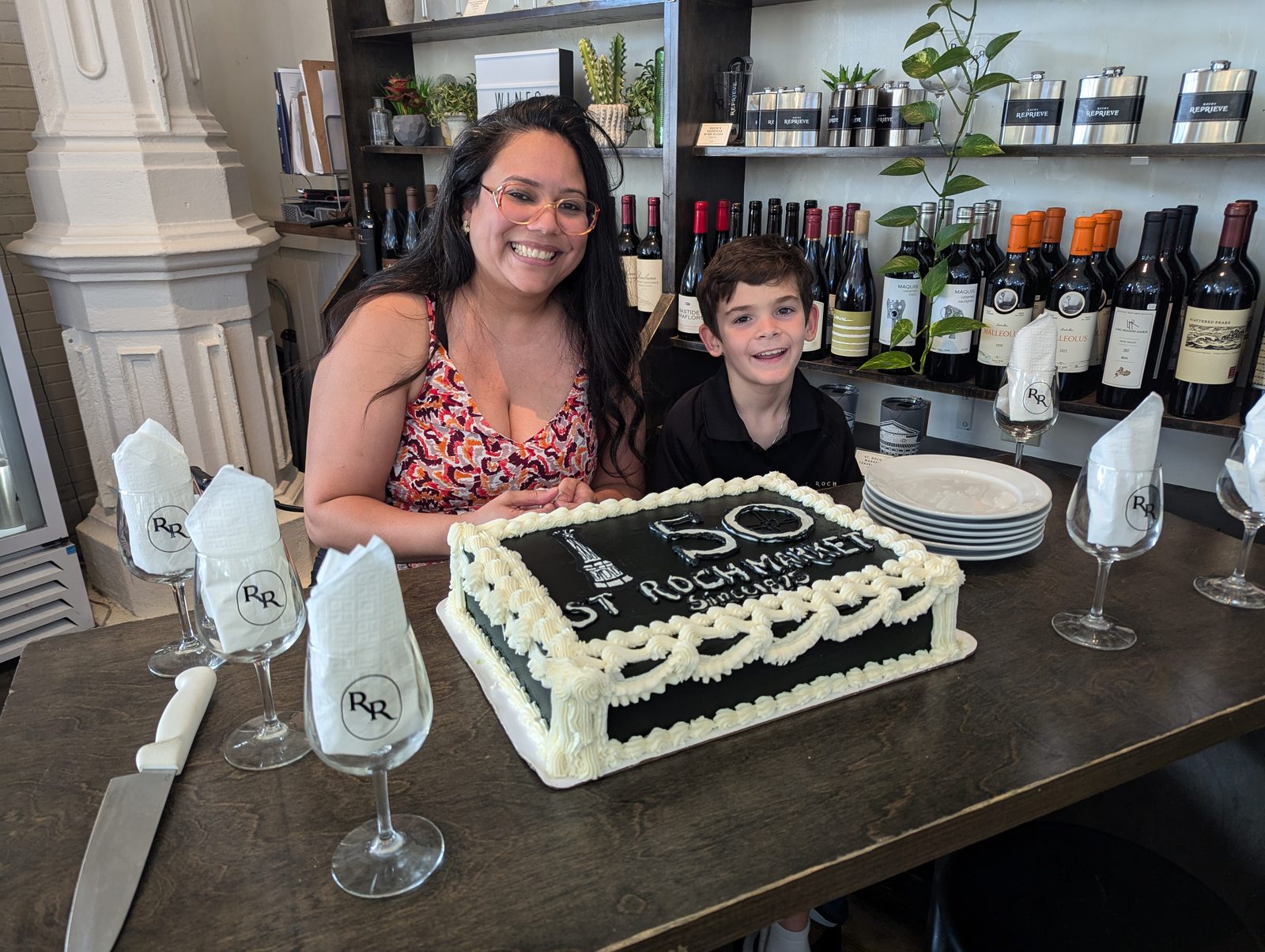 Guests celebrating with the 150th anniversary cake