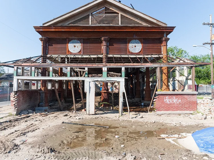 St. Roch Market devastated after Hurricane Katrina, showing exposed framing, graffiti, and debris
