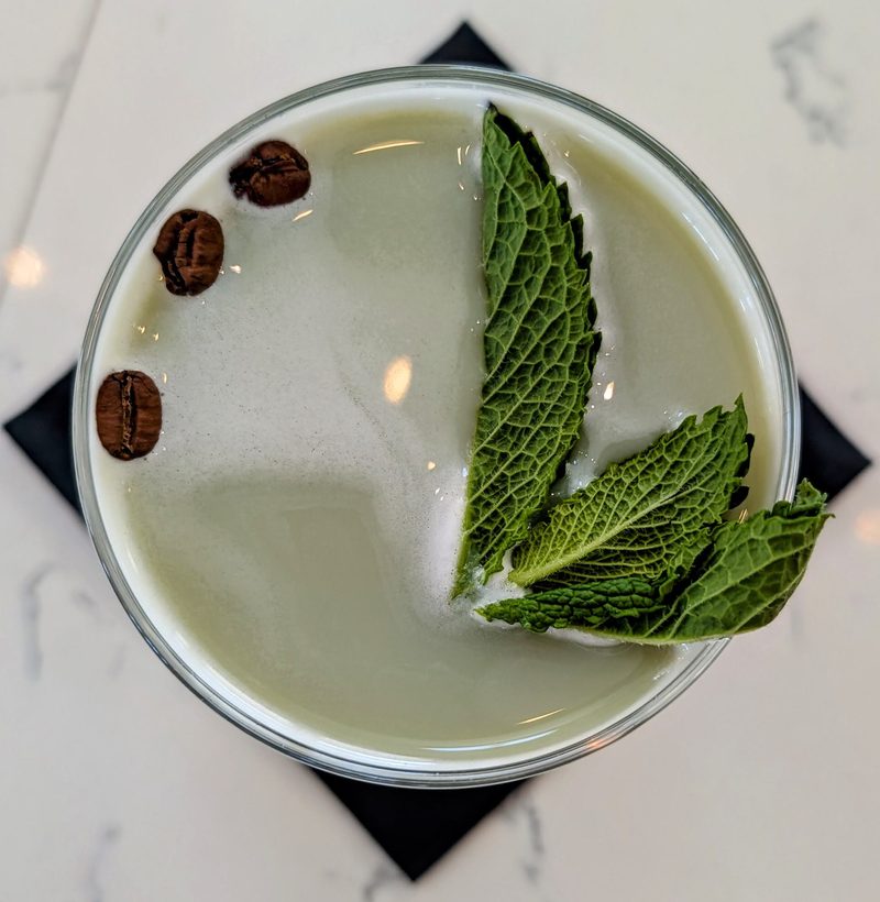 The Mint Espresso Martini garnished with fresh mint leaves and coffee beans at Roch's Reprieve